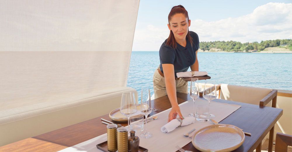 person in white shirt holding brown wooden table